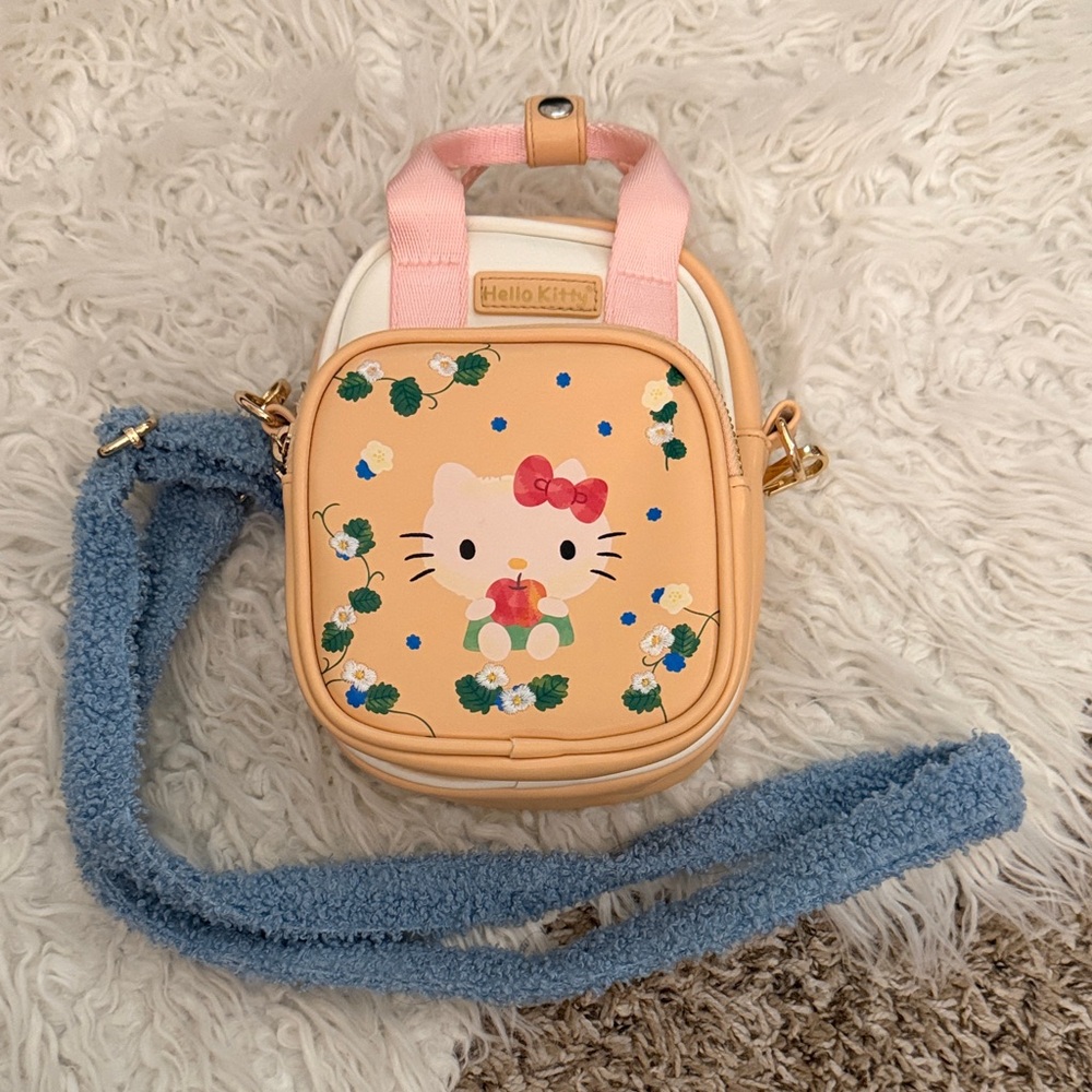 Hello Kitty Crossbody Bag with Pink Handles and clasp.